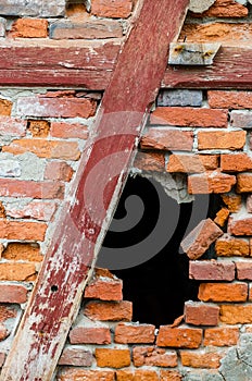 Hole in a red brick wall