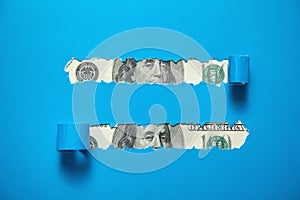 Hole ripped in paper with a dollar