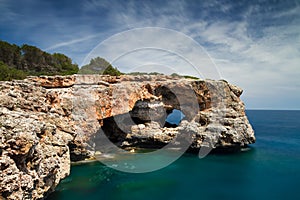 Hole in the rock at Cala Sa Nau photo