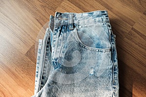 Hole and Threads on Denim Jeans. Ripped Destroyed Torn Blue jeans background.