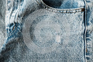 Hole and Threads on Denim Jeans. Ripped Destroyed Torn Blue jeans background.