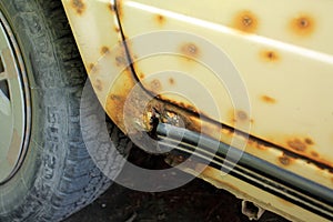 Hole in threshold of old car, damaged by rust and corrosion.