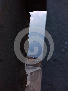 Hole view of cloud from wall.
