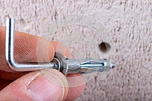 Hole in the wall, screw and dowel for fixing in concrete. Wall mounting methods