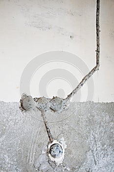 Hole in wall for socket. repar and construction. building concept. move to new apartment. concrete wall background. Cable laying