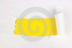 Hole In The White Paper With Torn Sides on Yellow Background