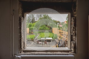 Hole in a window as the old windows were removed and the gap is ready to be closed with installation of new modern windows. House