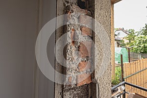 Hole in a window as the old windows were removed and the gap is ready to be closed with installation of new modern windows. House