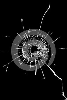 Hole in the window. Cracked broken black glass. Texture concept for design.