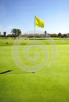 Hole and yellow flag in Costa Ballena Golf course, Rota, Cadiz province, Spaingreen,