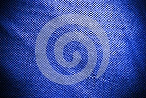 Holed and creased blue canvas background or texture