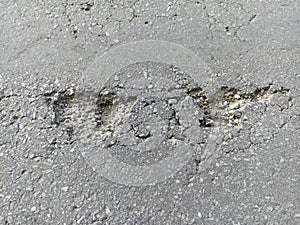 holes in the highway asphalt that endanger motorists