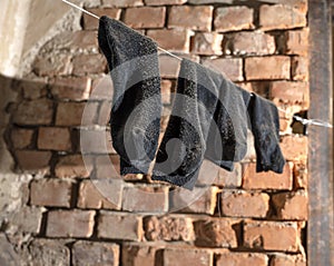 Holey old socks hanging on a rope photo