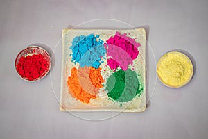 holi celebration plat decorated with colors from flat angle