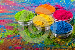 Holi color powder. Organic Gulal colours in bowl for Holi festival, Hindu tradition festive. Bright vibrant pigment closeup