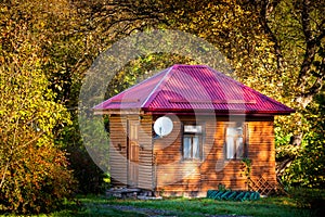 Holiday apartment - wooden cottage house in forest in early autumn