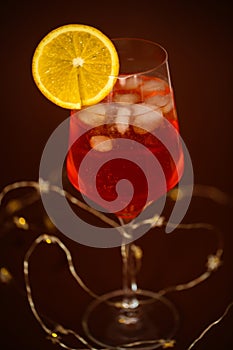 holiday aperitif with string lihgts and orange slice