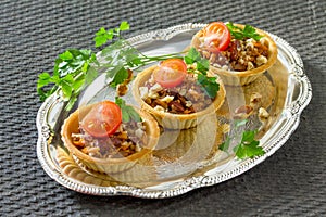 Holiday appetizer: tartlet with beans, meat and walnuts