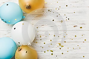 Holiday background with colorful balloon, gift and confetti. Flat lay style. Birthday or party greeting card with copy