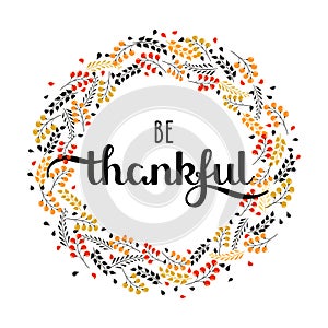 Holiday background with hand drawn words be thankful in a frma emade of leaves and berries