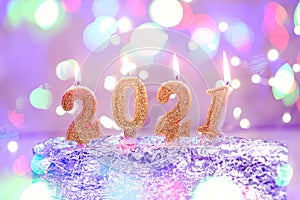 Holiday background Happy New Year 2021. Numbers of year 2021 made by gold burning candles on bokeh festive sparkling