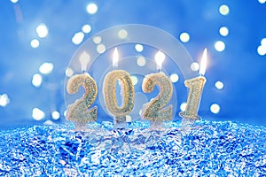 Holiday background Happy New Year 2021. Numbers of year 2021 made by gold burning candles on bokeh festive sparkling