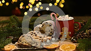 Holiday background Happy New Year 2024. cup and ginger man cookie on bokeh festive sparkling background.