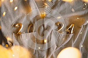 Holiday background Happy New Year 2024. Numbers of year 2024 with sweater