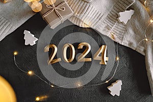 Holiday background Happy New Year 2024. Numbers of year 2024 with sweater