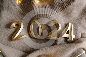 Holiday background Happy New Year 2024. Numbers of year 2024 with sweater