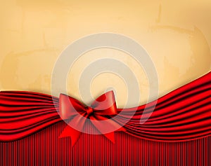 Holiday background with old paper and red gift bow