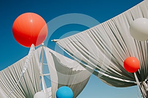 Holiday balloons outside decorated cloth sail sky