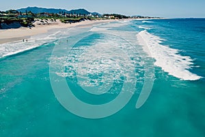 Holiday beach and ocean with waves in Floripa. Aerial view of Morro das Pedras