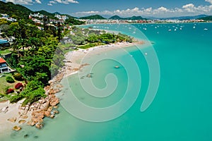 Holiday beach with turquoise quiet ocean in Florianopolis. Aerial view