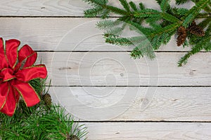 Holiday border of greenery in the upper right and lower left cor