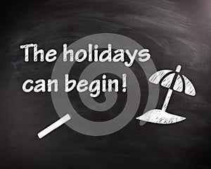 The Holiday can Begin Phrase on Black Chalkboard