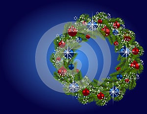Holiday card. Christmas wreath. Green fir branches with red and blue balls on blue background. Christmas decorations