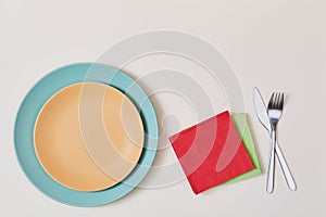 Holiday celebration. Festive event. Party time. Table setting. Top view of plates, napkins, fork and knife, copy space