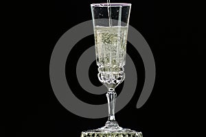 On a holiday, champagne is poured into a crystal glass