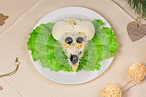 Holiday Christmas menu idea - salad looks like a rat mouse on a white plate in a festive scene
