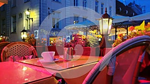 Holiday city light Street cafe  bokeh blurring city light evening restaurant table cup of coffee on top view candle lamp  light re