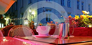 Holiday city light Street cafe  bokeh blurring city light evening restaurant table cup of coffee on top view candle lamp  light re