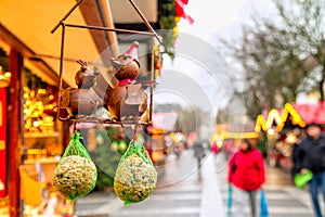 Holiday cityscape - view of souvenir metal birds with feed on background of the Christmas Market Weihnachtsmarkt