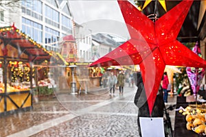Holiday cityscape - view of star in the form of decoration on background of the Christmas Market Weihnachtsmarkt in the city of photo