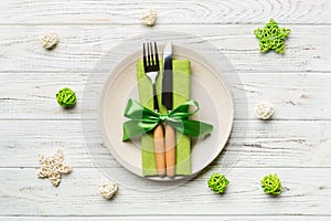 Holiday composition of Christmas dinner on wooden background. Top view of plate, utensil and festive decorations. New Year Advent