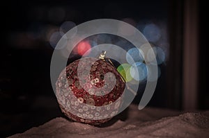 Holiday conceopt. Christmas background with baubles, on snow, free space for text. Christmas decoration. Festive background