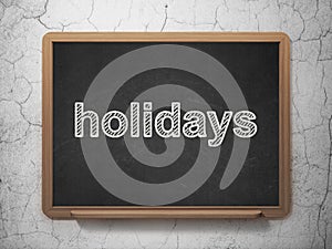 Holiday concept: Holidays on chalkboard background