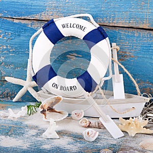 Holiday concept - maritime decoration - Toy boat with a blue life bouy