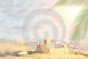 Holiday concept with sandcastle on the seaside. Summer background with copy space