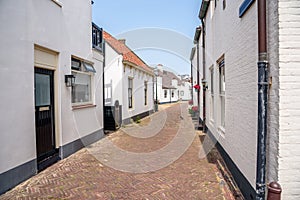 Holiday cottages along a stone alley in a seaside town on a clear summer day